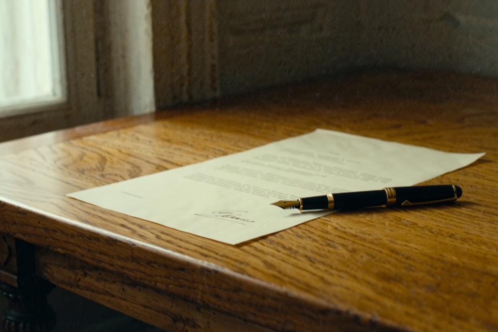 A crisp legal agreement with a signature line and a fountain pen
